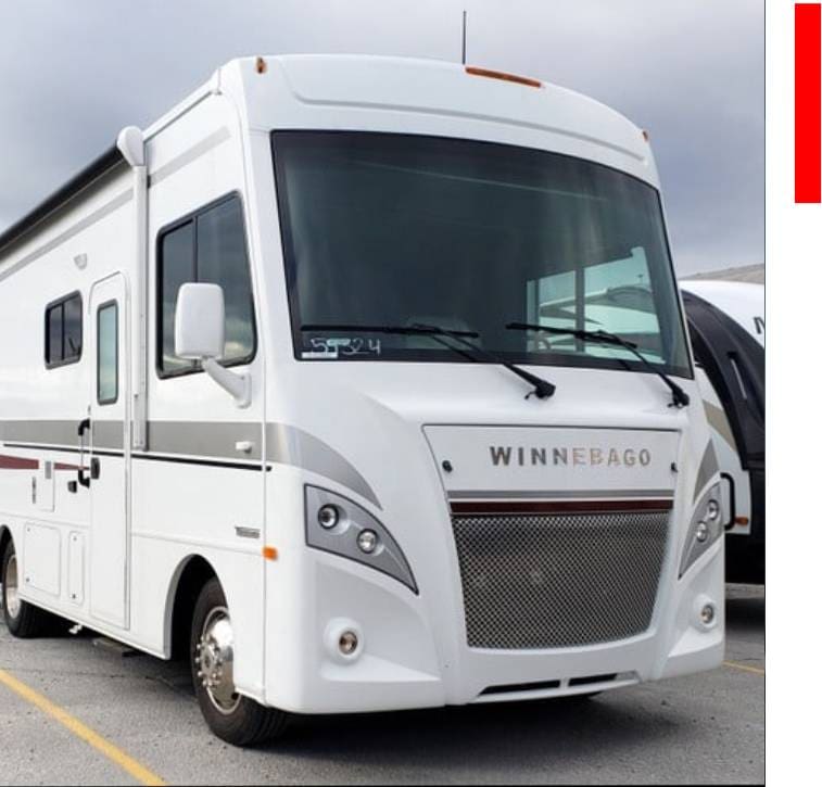 A white rv parked in the parking lot.