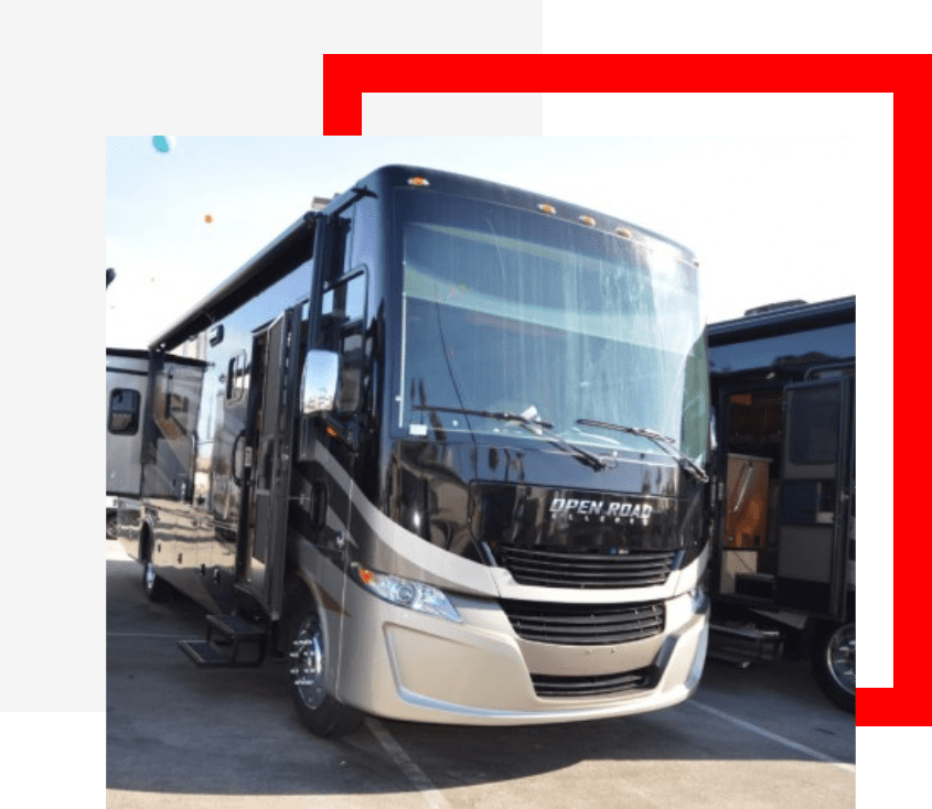 A black and silver rv parked in a parking lot.